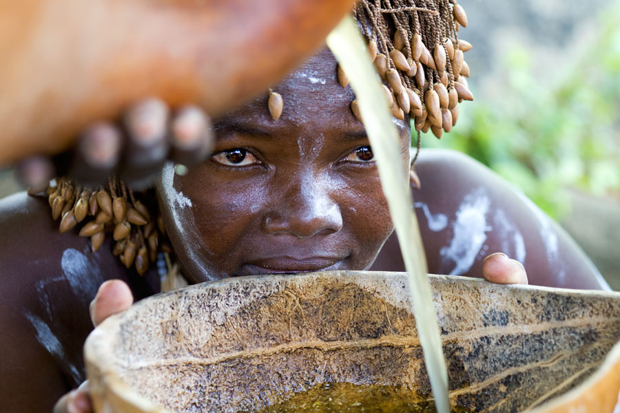  Drinking local brewed beer during a ceremonial dance of the Tharaka tribe. Kenya